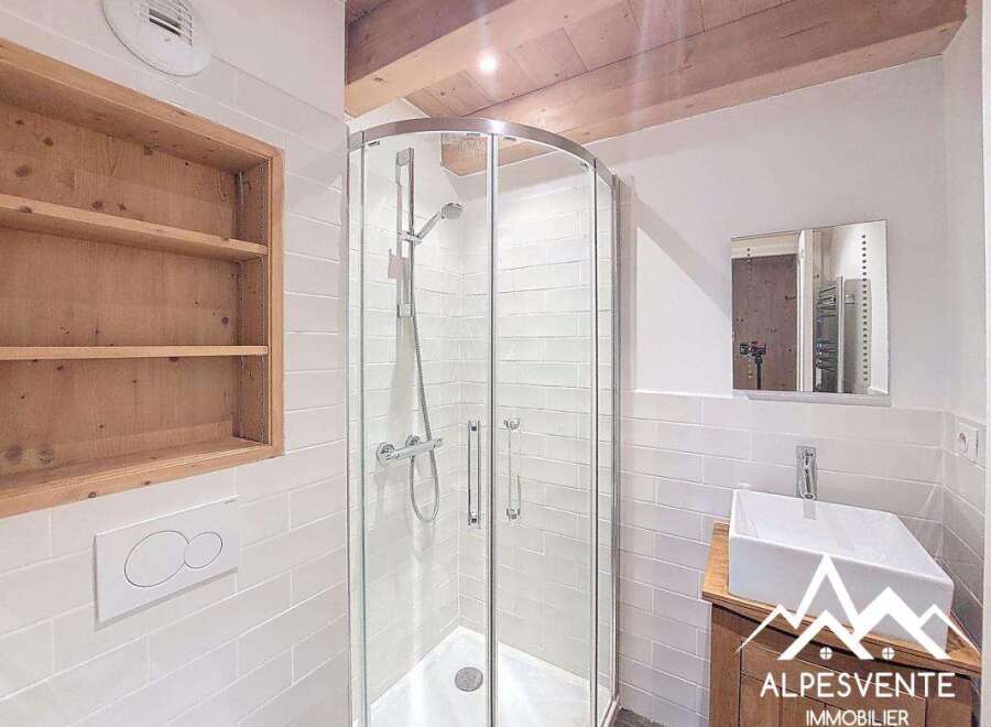 This stunning bathroom features a modern shower with glass doors and a sleek, minimalist design.