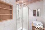 This stunning bathroom features a modern shower with glass doors and a sleek, minimalist design.