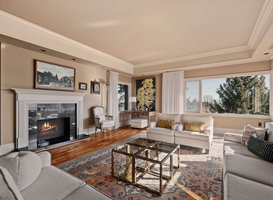 Step into luxury with this stunning living room, featuring a cozy fireplace and elegant design.