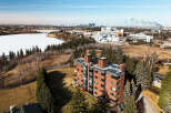 Discover urban living at its finest in this stunning property! This building boasts a prime location with breathtaking views of the city skyline and a serene, frozen lake.