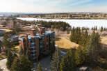 Discover luxury living in this stunning condo with breathtaking views of the frozen lake and surrounding nature.