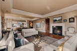 Step into luxury with this stunning living room, featuring a cozy fireplace and elegant white sofas.