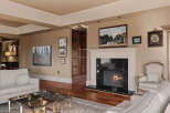 Step into luxury with this stunning living room, featuring a cozy fireplace and elegant hardwood floors.