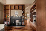This stunning property boasts a custom built-in bookshelf and fireplace, perfect for cozy evenings.