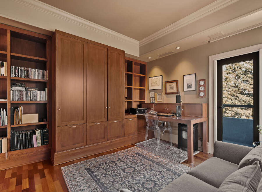 This stunning home office boasts custom built-in cabinetry, providing ample storage and a sleek, organized workspace.