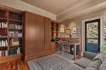 This stunning home office boasts custom built-in cabinetry, providing ample storage and a sleek, organized workspace.