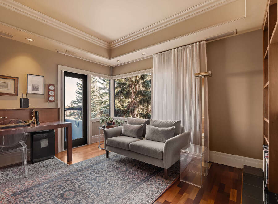 Step into luxury with this stunning living space, featuring a cozy gray sofa and a beautiful rug.