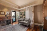 Step into luxury with this stunning living space, featuring a cozy gray sofa and a beautiful rug.