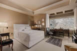 This elegant bedroom offers a serene retreat with its neutral color palette and sophisticated design.