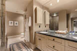 This luxurious bathroom boasts a sleek design and high-end finishes, perfect for a relaxing retreat.