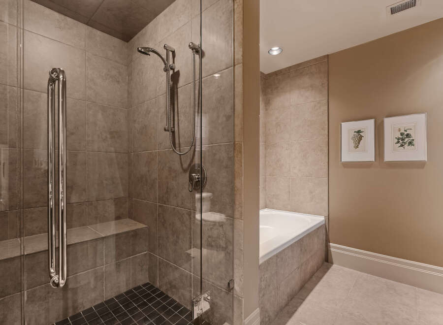 Step into luxury with this stunning bathroom featuring a spacious walk-in shower with a glass door.