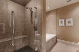 Step into luxury with this stunning bathroom featuring a spacious walk-in shower with a glass door.