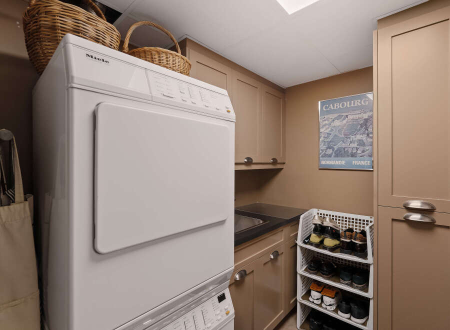 Discover the convenience of this well-appointed laundry room, featuring a modern Miele washer and dryer set.