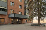This stunning brick building offers a welcoming entrance with a covered entryway, perfect for residents and guests.