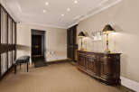 Step into luxury with this stunning entryway, featuring a beautifully crafted wooden console table and elegant lamps.