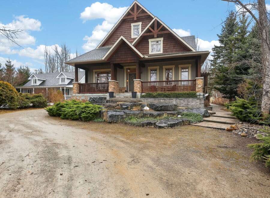 This stunning Craftsman-style home boasts exquisite architectural details and a welcoming facade.