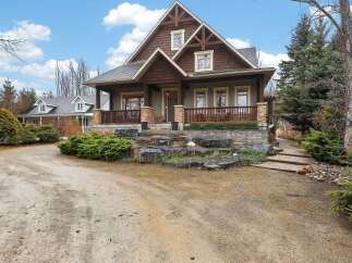 This stunning Craftsman-style home boasts exquisite architectural details and a welcoming facade.