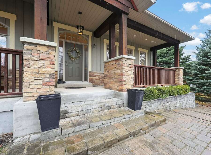 Welcome to this stunning home with a charming facade! The exterior boasts beautiful stone accents, a welcoming porch, and a well-manicured landscape.