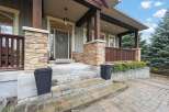 Welcome to this stunning home with a charming facade! The exterior boasts beautiful stone accents, a welcoming porch, and a well-manicured landscape.