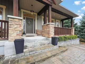 Welcome to this stunning home with a charming facade! The exterior boasts beautiful stone accents, a welcoming porch, and a well-manicured landscape.