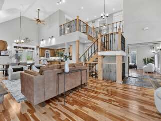 Step into luxury with this stunning property, boasting a grand two-story design and exquisite hardwood floors throughout.