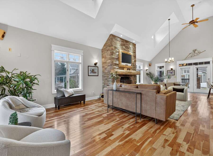 Step into luxury with this stunning living room, featuring a cozy fireplace and a modern design.