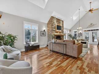 Step into luxury with this stunning living room, featuring a cozy fireplace and a modern design.