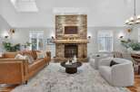 This stunning living room features a cozy fireplace with a stone facade, perfect for those chilly evenings.