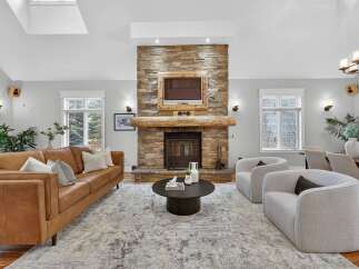 This stunning living room features a cozy fireplace with a stone facade, perfect for those chilly evenings.