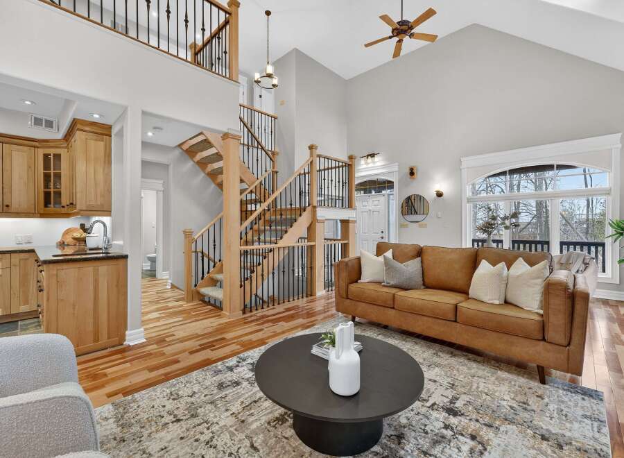 Step into luxury with this stunning home featuring a grand staircase and an open-concept living area.
