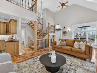Step into luxury with this stunning home featuring a grand staircase and an open-concept living area.