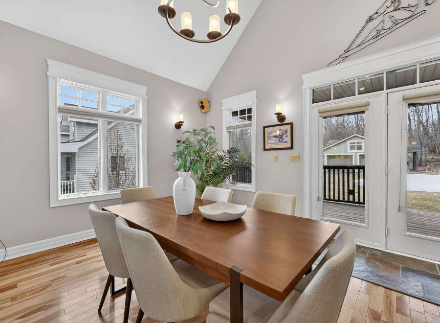 This stunning dining room features a modern wooden table, perfect for hosting gatherings.