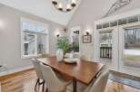 This stunning dining room features a modern wooden table, perfect for hosting gatherings.
