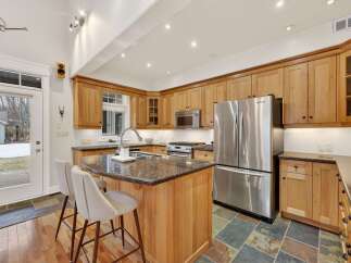 This stunning kitchen boasts custom cabinetry, a spacious island with seating, and high-end stainless steel appliances.