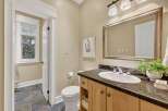 Step into this beautifully designed bathroom, featuring a stylish vanity with ample storage and a sleek countertop.