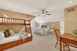 This spacious bedroom features a cozy bunk bed and a comfortable queen-sized bed, perfect for accommodating guests or family.