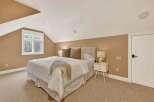 This cozy bedroom features a comfortable bed with soft bedding and decorative pillows, creating a relaxing atmosphere.