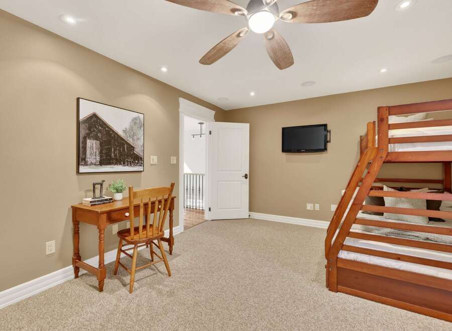 This inviting bedroom features a cozy bunk bed, perfect for accommodating guests or family.