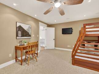 This inviting bedroom features a cozy bunk bed, perfect for accommodating guests or family.