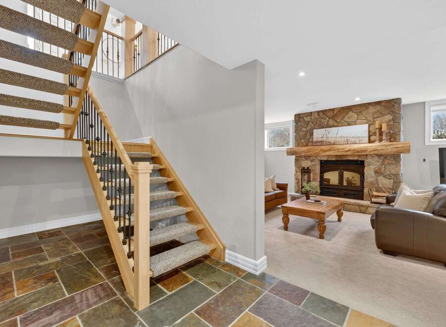 This stunning property boasts a beautifully designed staircase leading to a cozy living area.