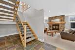 This stunning property boasts a beautifully designed staircase leading to a cozy living area.