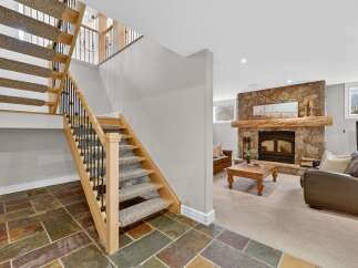 This stunning property boasts a beautifully designed staircase leading to a cozy living area.