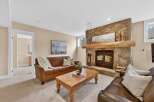 Step into luxury with this stunning living room featuring a cozy fireplace and elegant leather sofas.