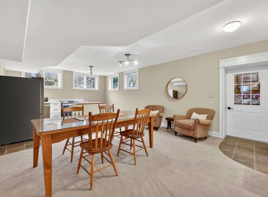 This inviting space features a dining area with a wooden table and chairs, perfect for gatherings.