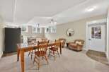 This inviting space features a dining area with a wooden table and chairs, perfect for gatherings.