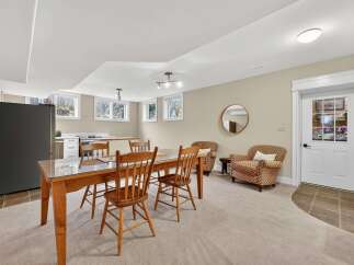 This inviting space features a dining area with a wooden table and chairs, perfect for gatherings.