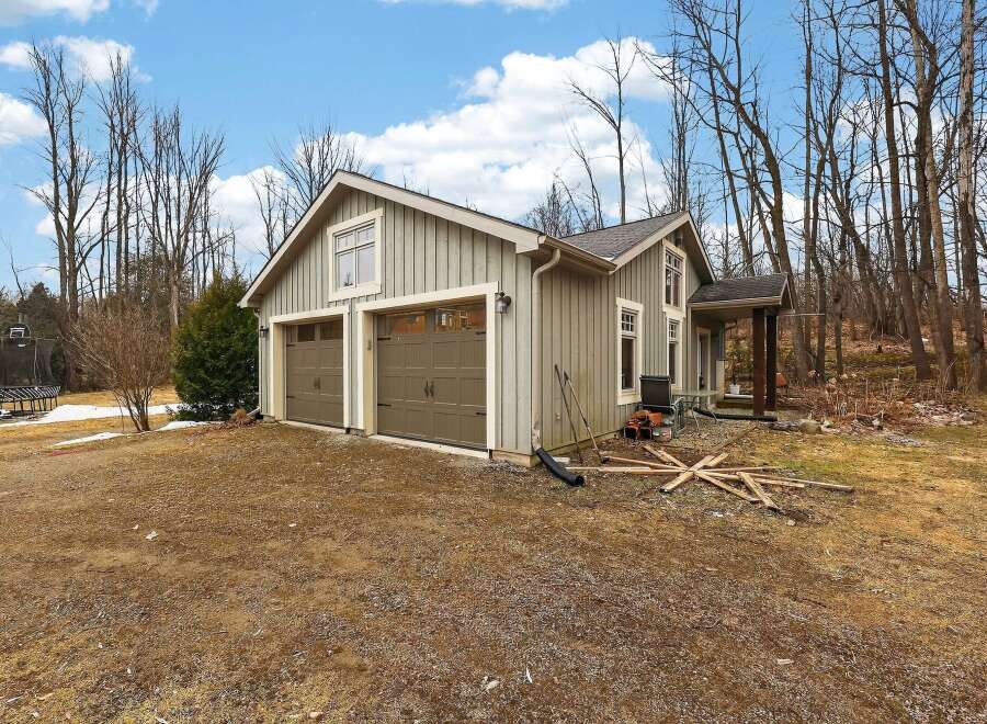 This charming property features a detached garage with two bays, perfect for storing vehicles or creating a workshop.