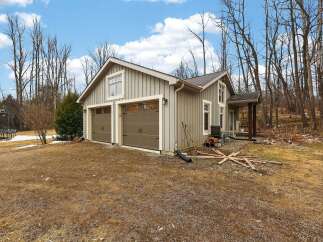 This charming property features a detached garage with two bays, perfect for storing vehicles or creating a workshop.