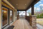 Step into luxury with this stunning home featuring a spacious covered porch, perfect for enjoying the outdoors in any weather.