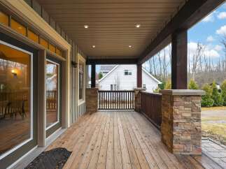 Step into luxury with this stunning home featuring a spacious covered porch, perfect for enjoying the outdoors in any weather.